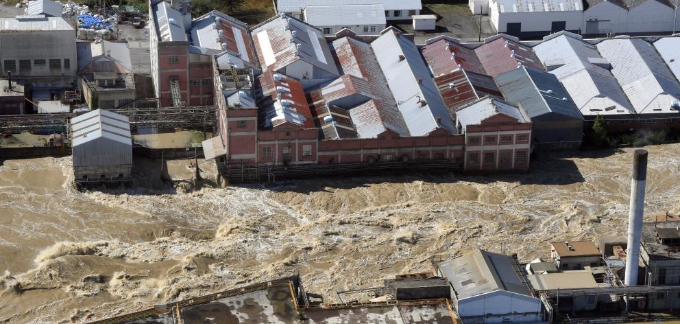 The flooded Mataura River gushes past the former paper mill earlier this week. PHOTO: STEPHEN...