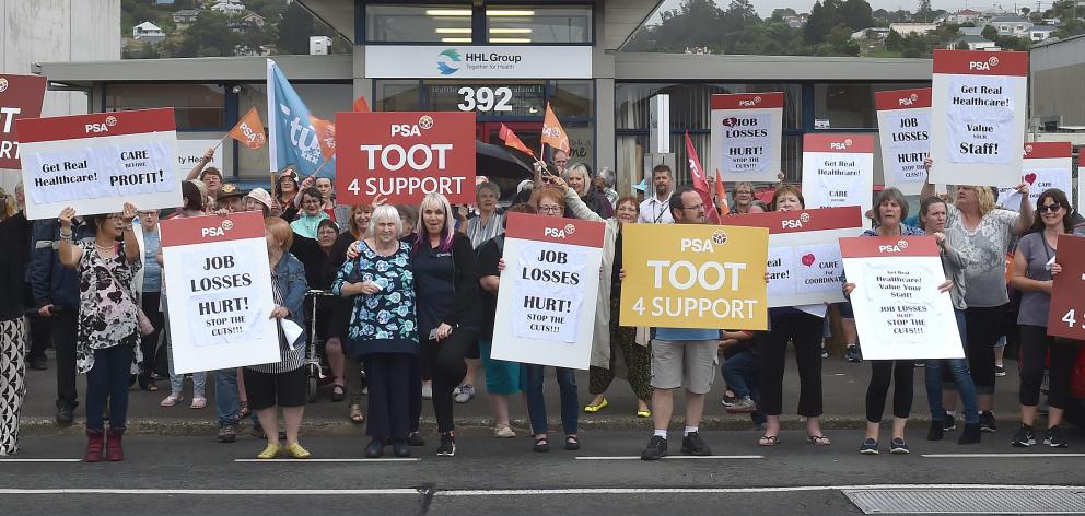 Protesters, including some Public Service Association members, hold placards in Hillside Rd,...