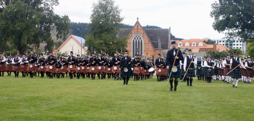 City of Invercargill pipe band members in black shirts and red kilts outnumber other pipe band...