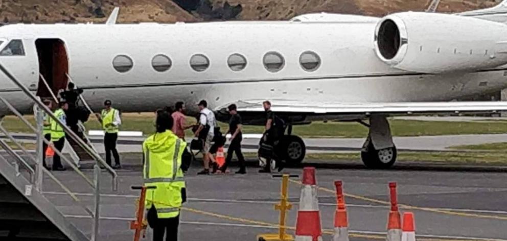 Tom Cruise wearing black, second from right about to depart from Queenstown. Photo: Supplied