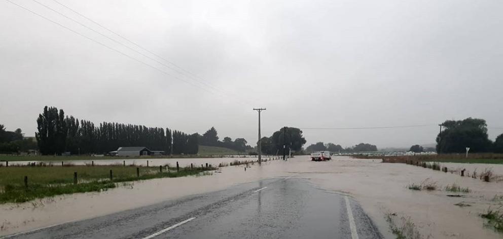 Waikaka Rd, at the intersection with East Chatton Rd, where water is almost to the top of the road markers. Photo: Gore District Council