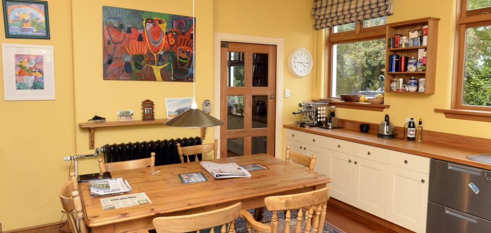 The kitchen was expanded by removing a servery between it and the dining room. The large painting...