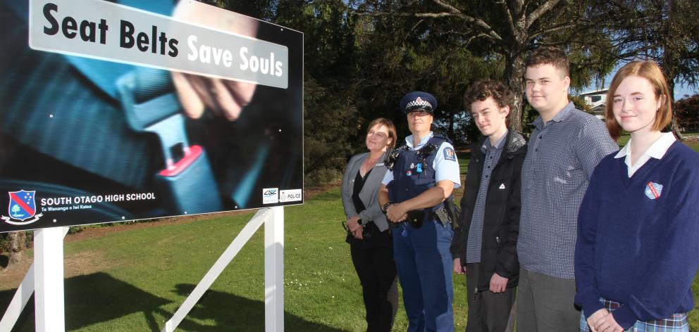 Presenting one of six new road safety billboards designed by South Otago pupils are (from left)...