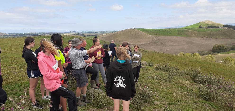 Sheep and beef farmer Ian McNaughton points out his property’s boundaries.