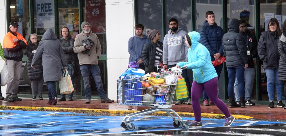 Customers queue outside Countdown central Dunedin last week prior to the lockdown. PHOTO: STEPHEN...