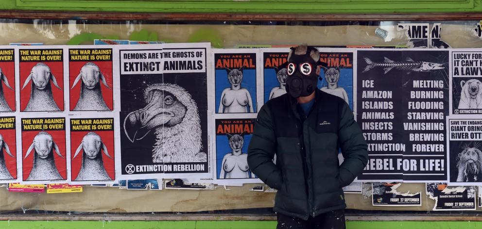 Toothfish stands in front of a completed composition on a disused George St shop window. Photos:...