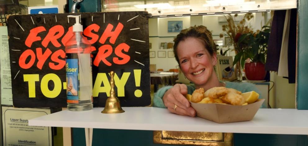 Order up ... Best Cafe owner Jessica Marks serves takeaway orders to a customer yesterday while...