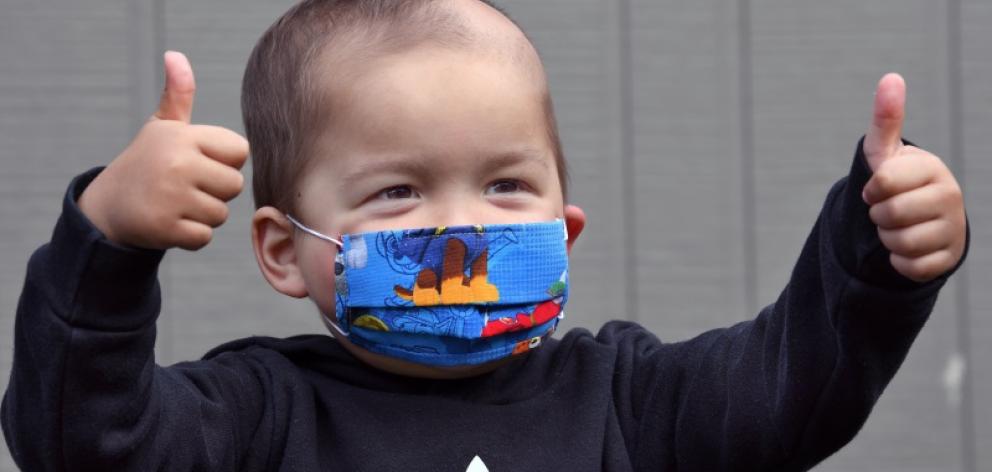 Happy and protected ... Two-year-old Phoenix Ratahi wears a mask made by his grandmother. PHOTOS:...