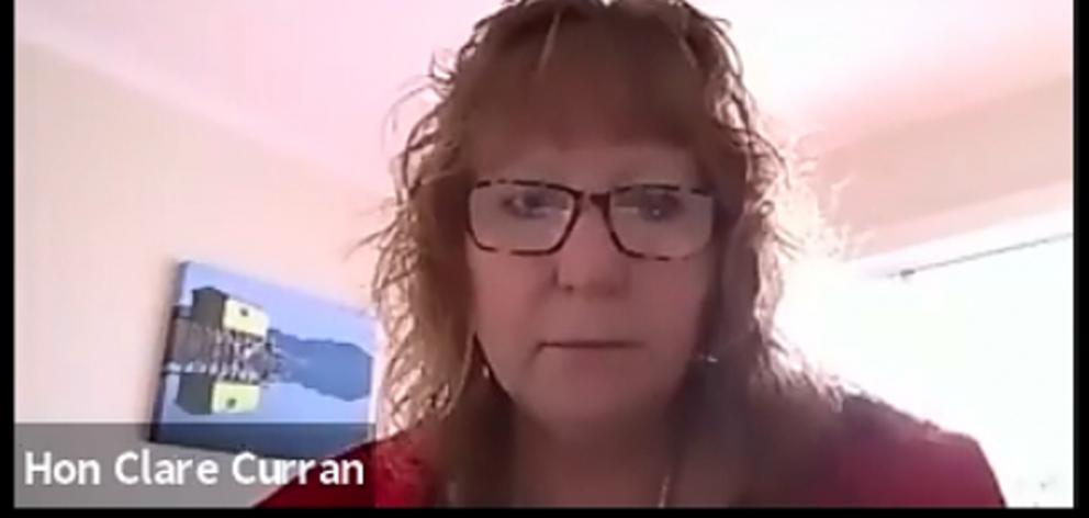 Clare Curran addresses a select committee from home with a painting of a peninsula landscape...