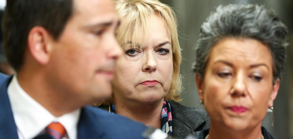 MP Judith Collins and deputy leader Paula Bennett look on while Leader Simon Bridges speaks to media after a caucus meeting at Parliament on October 16, 2018. Photo: Getty Images