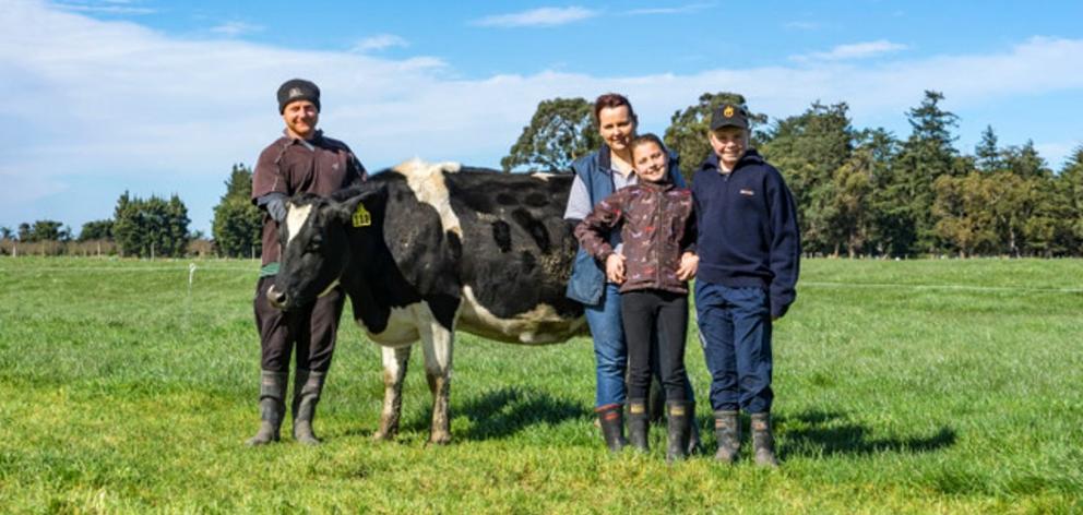 Mark Williams, wife Kelsey and children Addison and Reeve admire Mark's favourite A2 milker, 111....