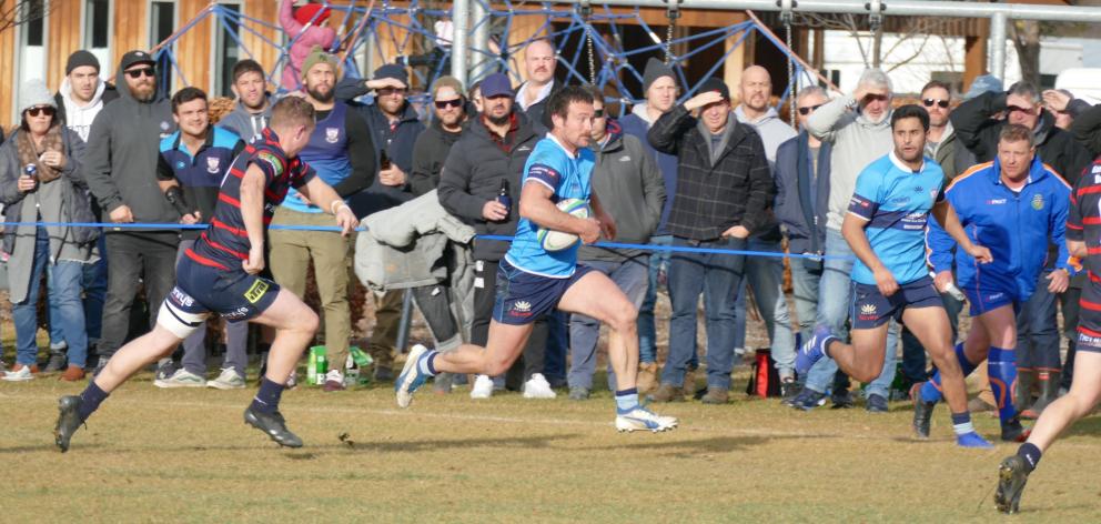 Wakatipu's Sam Collins makes a run for it at Jack Reid Park on Saturday, during his team's game...