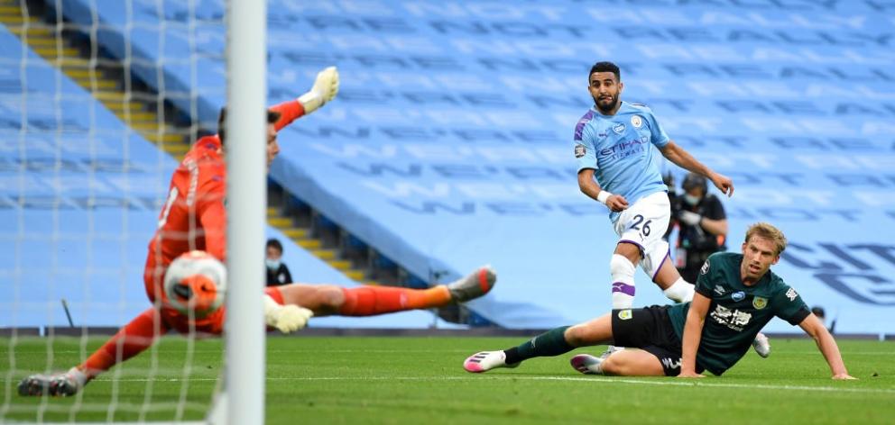 Riyad Mahrez scores for Manchester City in their win over Burnley this morning. Photo: Getty Images