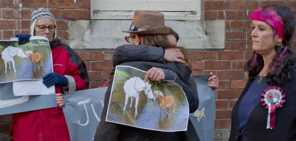 Mandy Mayhem-Bullock (right) looks on as her husband, Lee, is embraced by a supporter after...