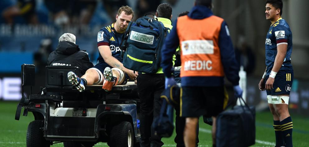 Highlanders lock Josh Dickson is taken off the field during a Super Rugby Aotearoa match against...