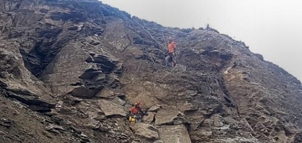 Abseilers work on a large slip near Cromwell yesterday above State Highway 8. PHOTO: SUPPLIED
