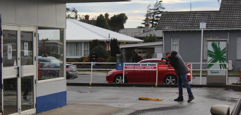 A police photographer documents evidence at the scene. PHOTOS: ABBEY PALMER
