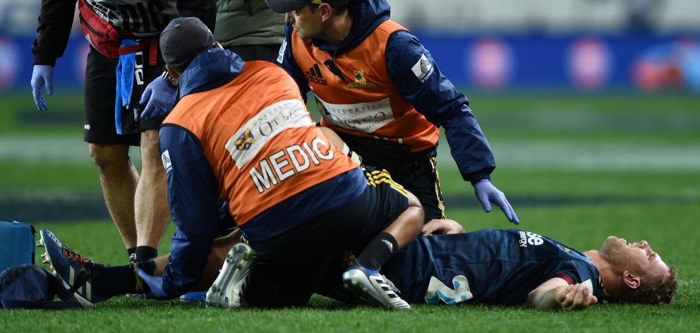 Josh Dickson of the Highlanders was taken off injured during the match against the Crusaders at...