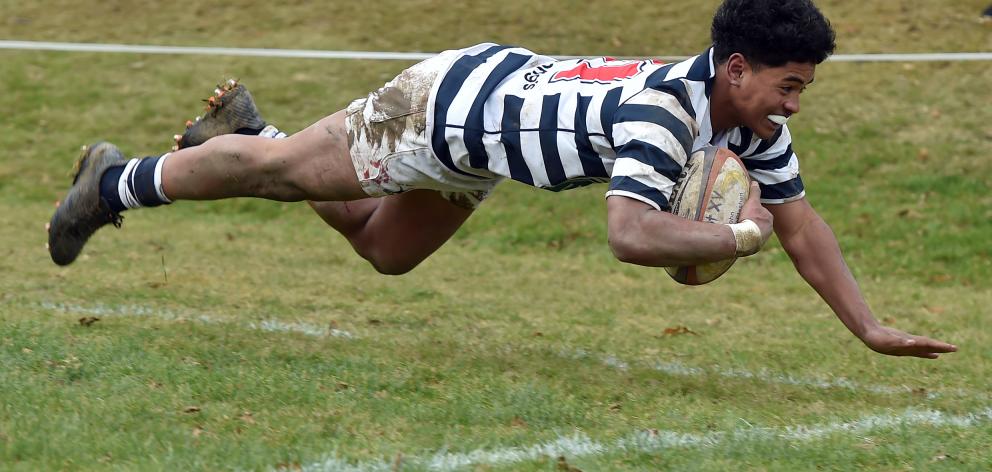 Otago Boys High School winger Hopoate Finau goes over to score a try during the Otago Boys High...