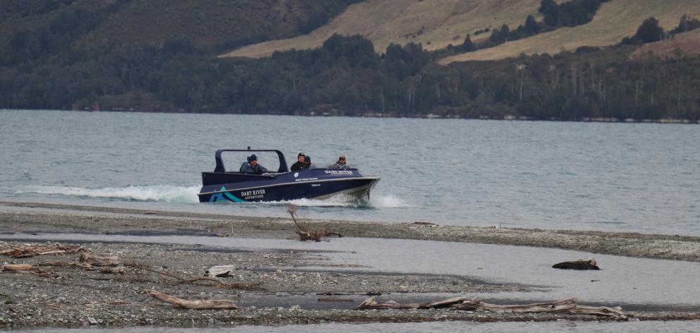 A jet-boat from Dart River Adventures carries police officers as they look for the body of Martin...