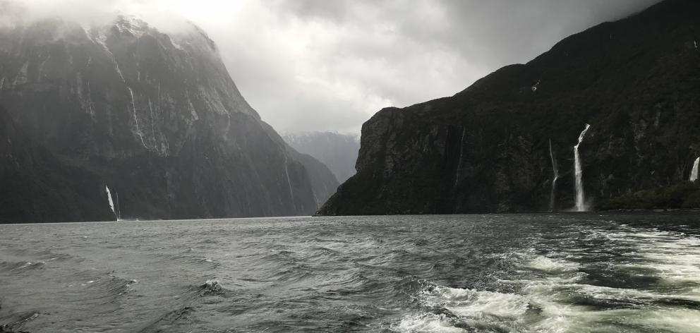 Waterfalls come to life during a storm in Milford Sound.