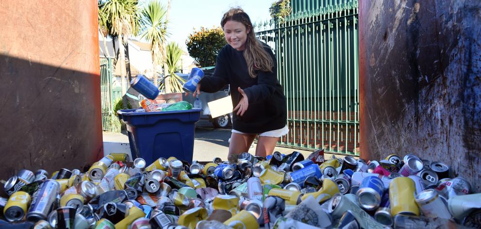 University of Otago student Kate Higham (19) contributes cans for recycling. 