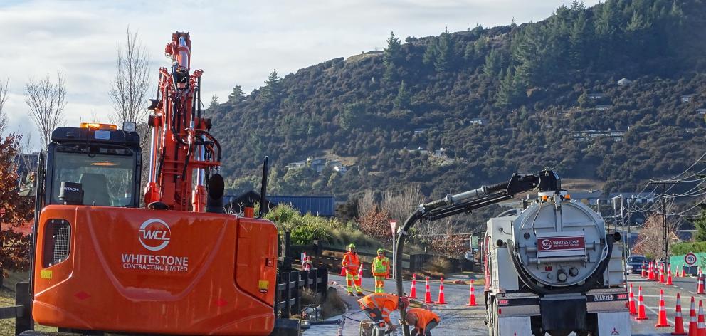 Contractors pump out the last of the floodwaters on Aubrey Rd, Wanaka. PHOTOS: KERRIE WATERWORTH