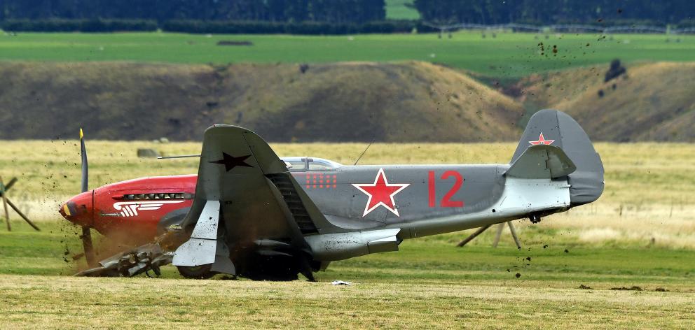 A World War 2 Yak 3 fighter plane slides to a halt after hitting  a cherry picker on the grass...