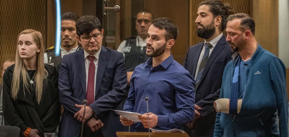Dunedin man Mustafa Boztas, surrounded by supporters, gives a victim impact statement during the...