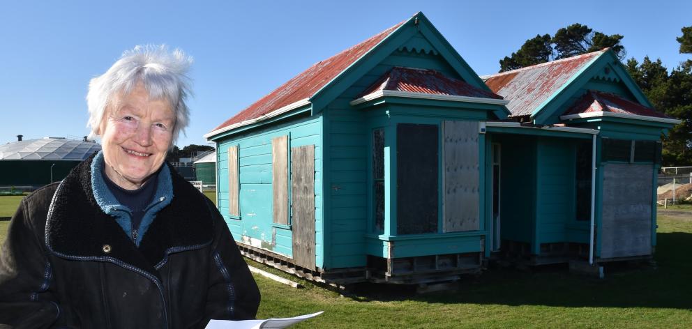 Heritage campaigner Ann Barsby stands next to the 19th-century Dunedin worker’s cottage that she...