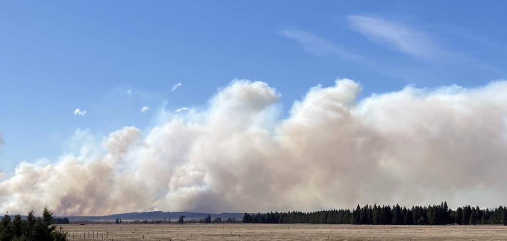 Smoke from a large fire sweeps across the Ben Ohau range, obscuring the mountains from view. The...
