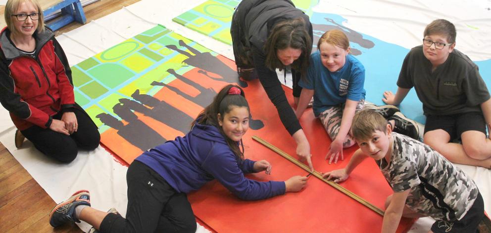 Rimu Full Primary School principal Kate Webster overlooks artist Jemima Pedro working with pupils...