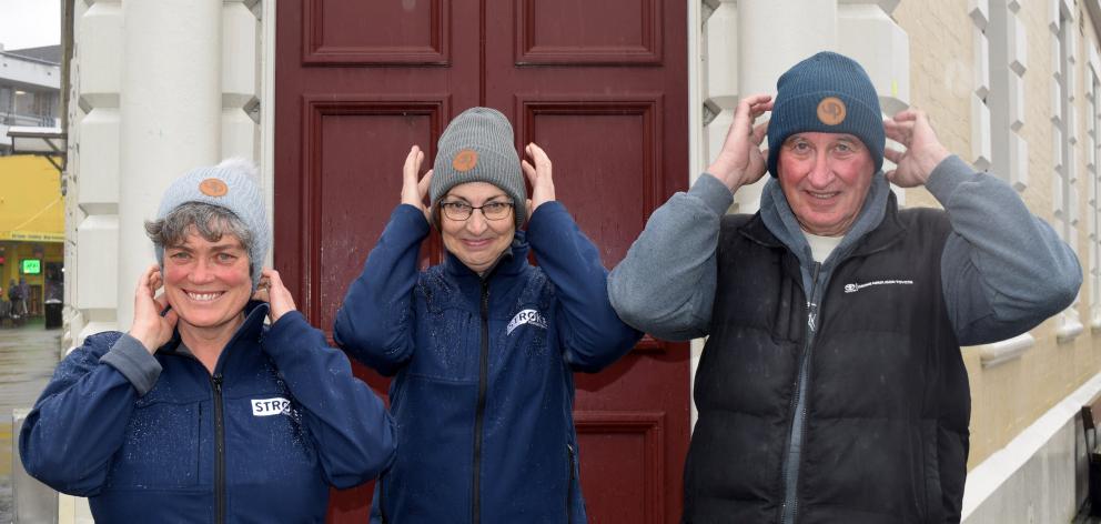 Pulling on beanies outside Community House in central Dunedin (from left) are Stroke Foundation...