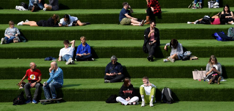 People are seen relaxing in an outdoor seating area while social distancing in London. Photo: Reuters People are seen relaxing in an outdoor seating area while social distancing in London. Photo: Reuters