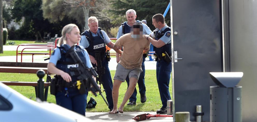 Police arrest a man in Memorial Park, Mosgiel, yesterday, after he allegedly assaulted a...