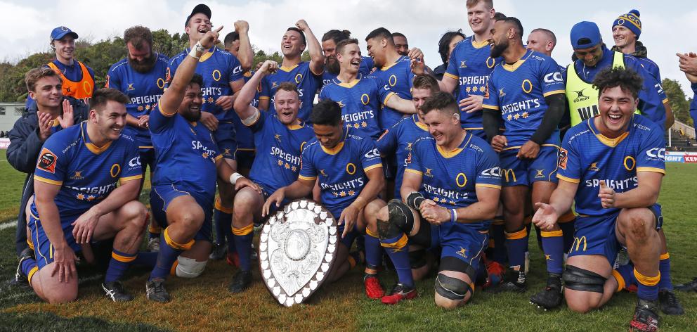 Otago players look lovingly at the old Log o' Wood. Photo: Getty Images