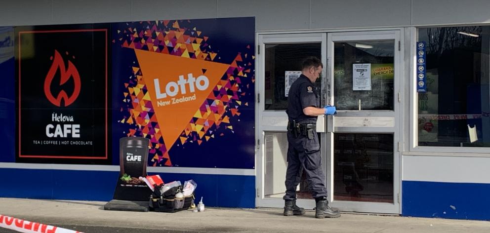 A police officer examining the scene in Invercargill today. Photo: Abbey Palmer