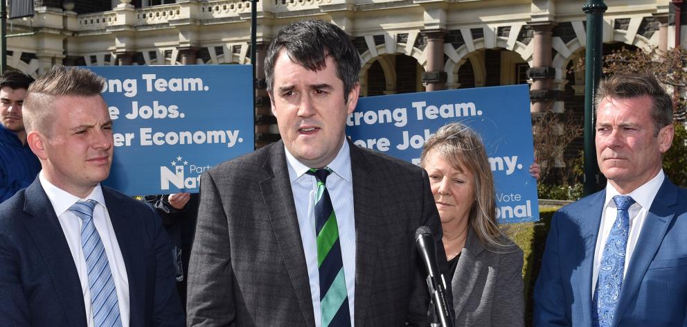 National Party transport spokesman Chris Bishop (centre) announces the party’s 
...