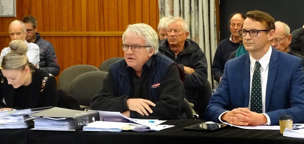 Coastguard Wanaka Lakes president Jonathan Walmisley (centre), flanked by counsel for the...