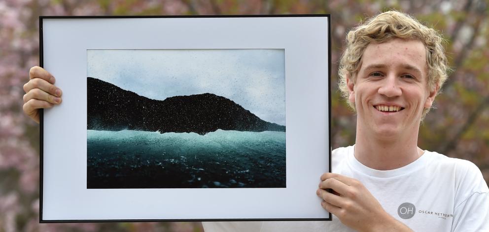 Otago Polytechnic student Oscar Hetherington (19) holds his prize-winning seascape photo. PHOTO:...