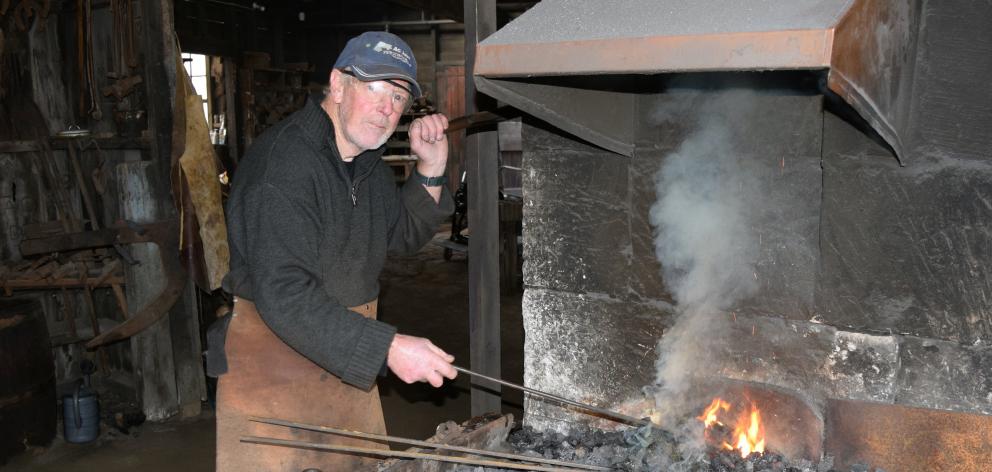 Nicol’s Blacksmith Shop volunteer John Stannard heats metal in a forge in Duntroon.
