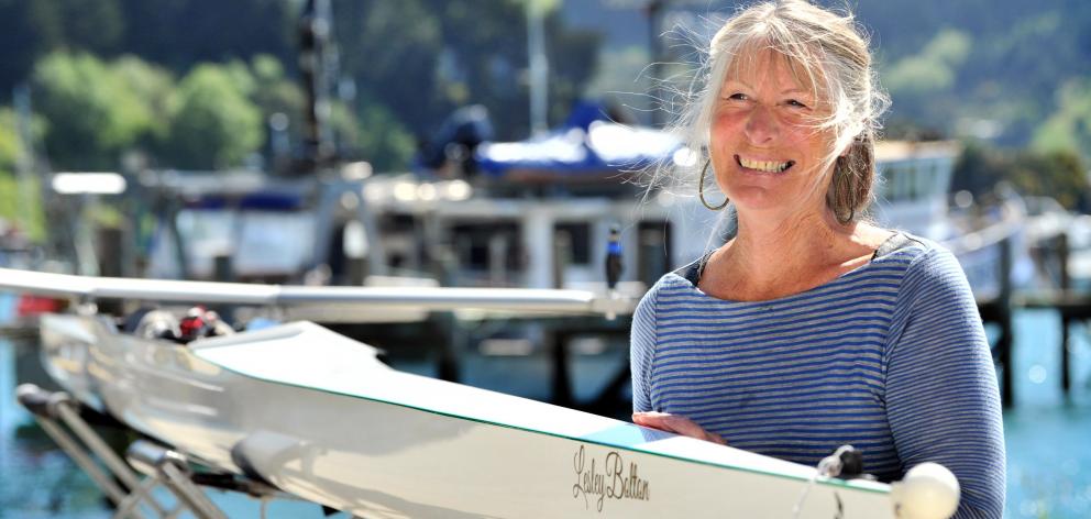 Lesley Bolton smiles while holding the boat named after her at the Port Chalmers United Rowing...