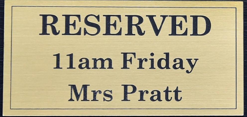 A plaque reserving Mrs Pratt’s seat at the salon every Friday at 11am. PHOTO: PETER MCINTOSH
