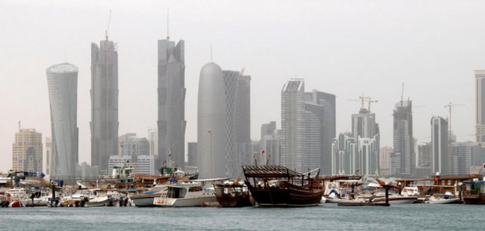 Traditional fishing Dhows are seen in port near modern glass and steel buildings on the Doha skyline. Photo: Reuters