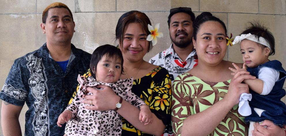 New citizens hug their daughters in the Dunedin Centre last week. They are friends Jackielynn...