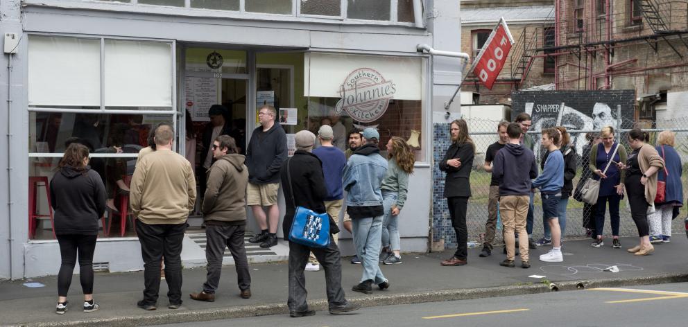 Customers queue for lunch on the last day of Johnnie’s Southern Kitchen in Rattray St. PHOTO:...