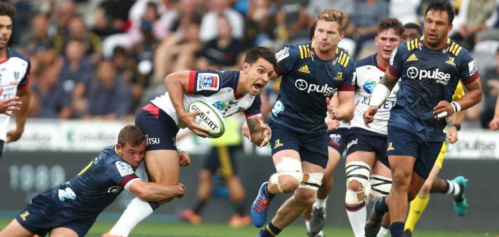 Rebels first five-eighth Matt Toomua is tackled during the side's match against the Highlanders...