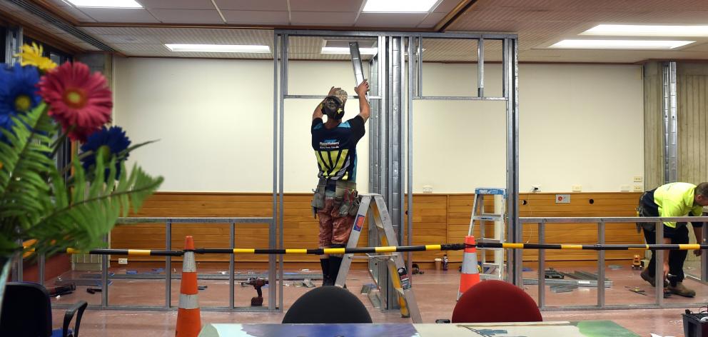 Workmen construct the prayer room on the Dunedin Public Library’s first floor yesterday.PHOTO...