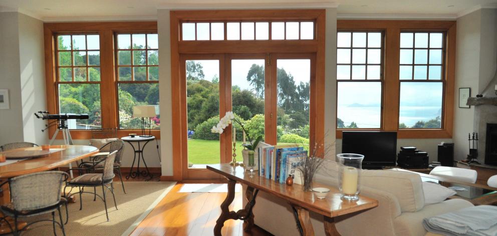 The front living area opens through bifold doors on to a deck and panoramic views of Otago...
