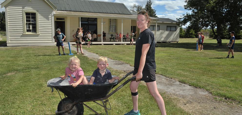 Camp warden Melinda Leslie takes Hazel Peddie (4) and Finlay Rae (5) for a wheelbarrow ride at...